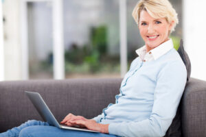 Smiling older lady with a laptop